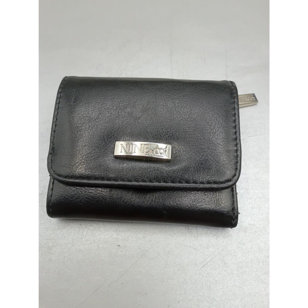 Nine & Co. faux leather small folding wallet featuring a front flap and a Snap